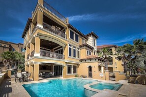 A multi-story hotel with a pool, balconies, and outdoor seating. - Gigglin Marlin 7 Bedroom Holiday Home by Five Star Properties (Destin)