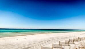 A beach with a clear sky and calm sea.