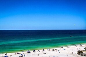A beach with clear turquoise waters, umbrellas, and people relaxing. - ST MAARTEN 808 3 Bedroom Holiday Home by Five Star Properties (Destin)