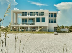 A modern beach house with a flat roof, large windows, and a balcony overlooking the beach. - The White House of Holiday Isle 6 Bedroom Holiday Home by Five Star Properties (Destin)
