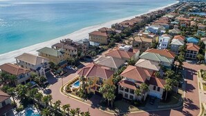 A coastal residential area with houses, a beach, and a clear sky. - Tuscan Villa 5 Bedroom Holiday Home by Five Star Properties (Destin)