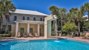 A pool area with a clear blue pool, lounge chairs, and a covered seating area with a pergola. - Ventanas al Paraiso 5 Bedroom Holiday Home by Five Star Properties (Miramar Beach)