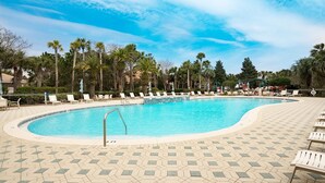 A swimming pool with lounge chairs and palm trees. - Villa Destiny 6 Bedroom Holiday Home by Five Star Properties (Destin)