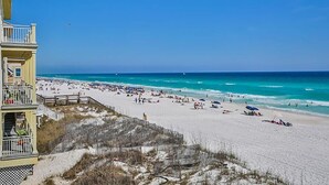 A beach with a building on the left.