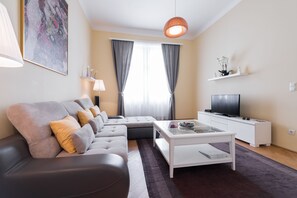 Deluxe Condo, 1 Bedroom, City View | Living room | Flat-screen TV