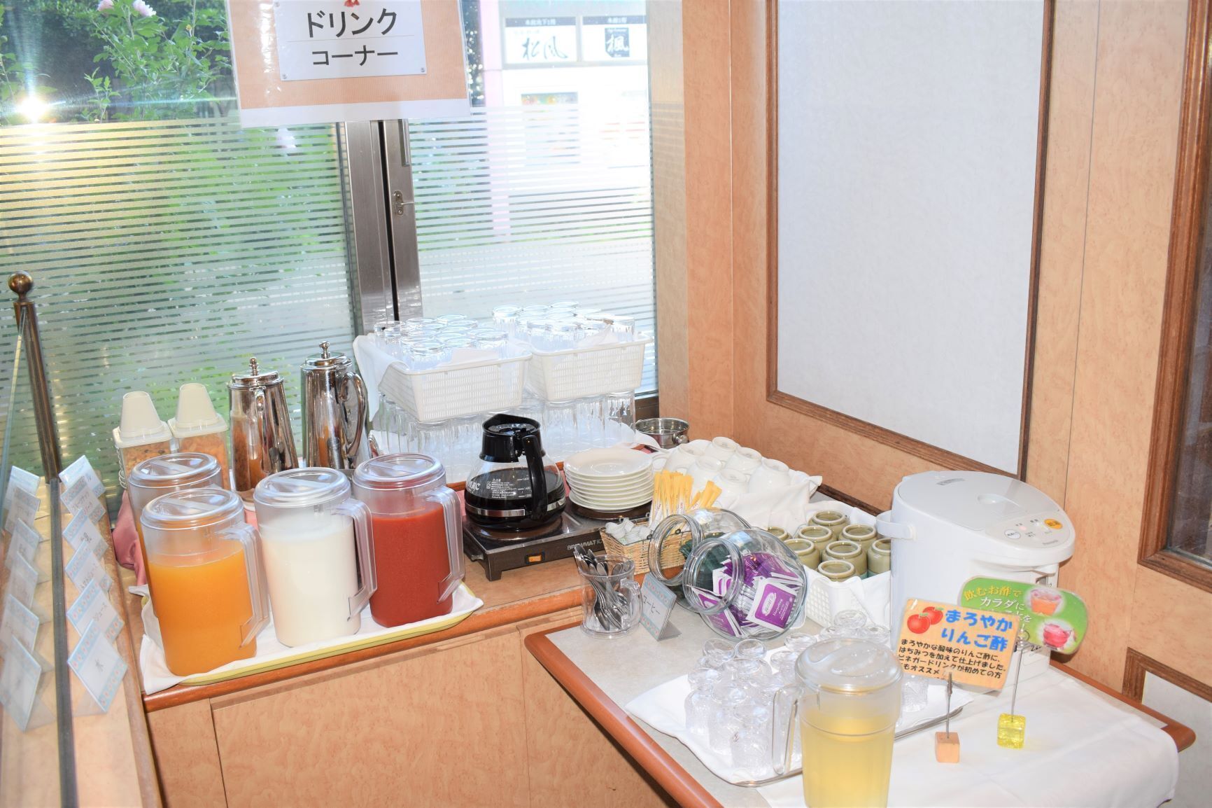 A breakfast buffet setup with various food items and beverages.