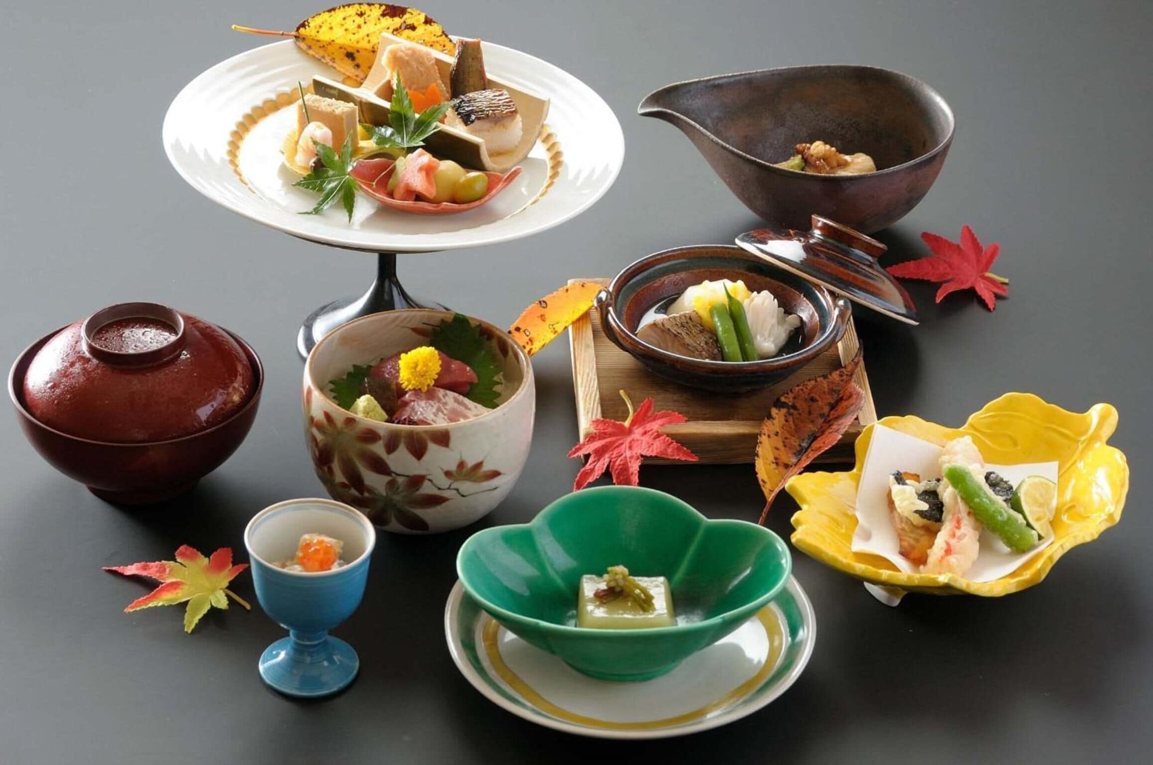 A variety of traditional Japanese dishes and utensils on a table.