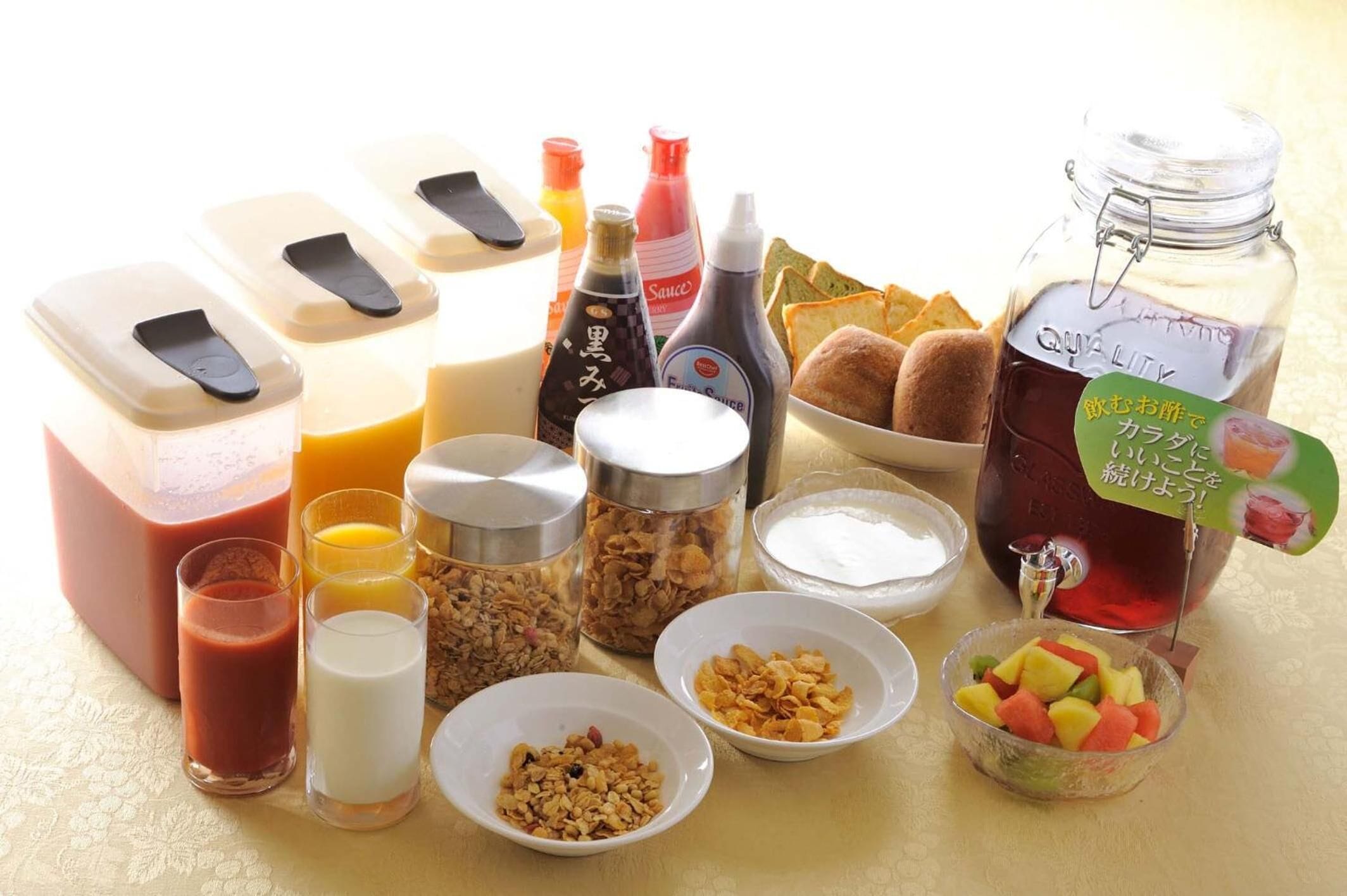 A breakfast spread with various food items and condiments.