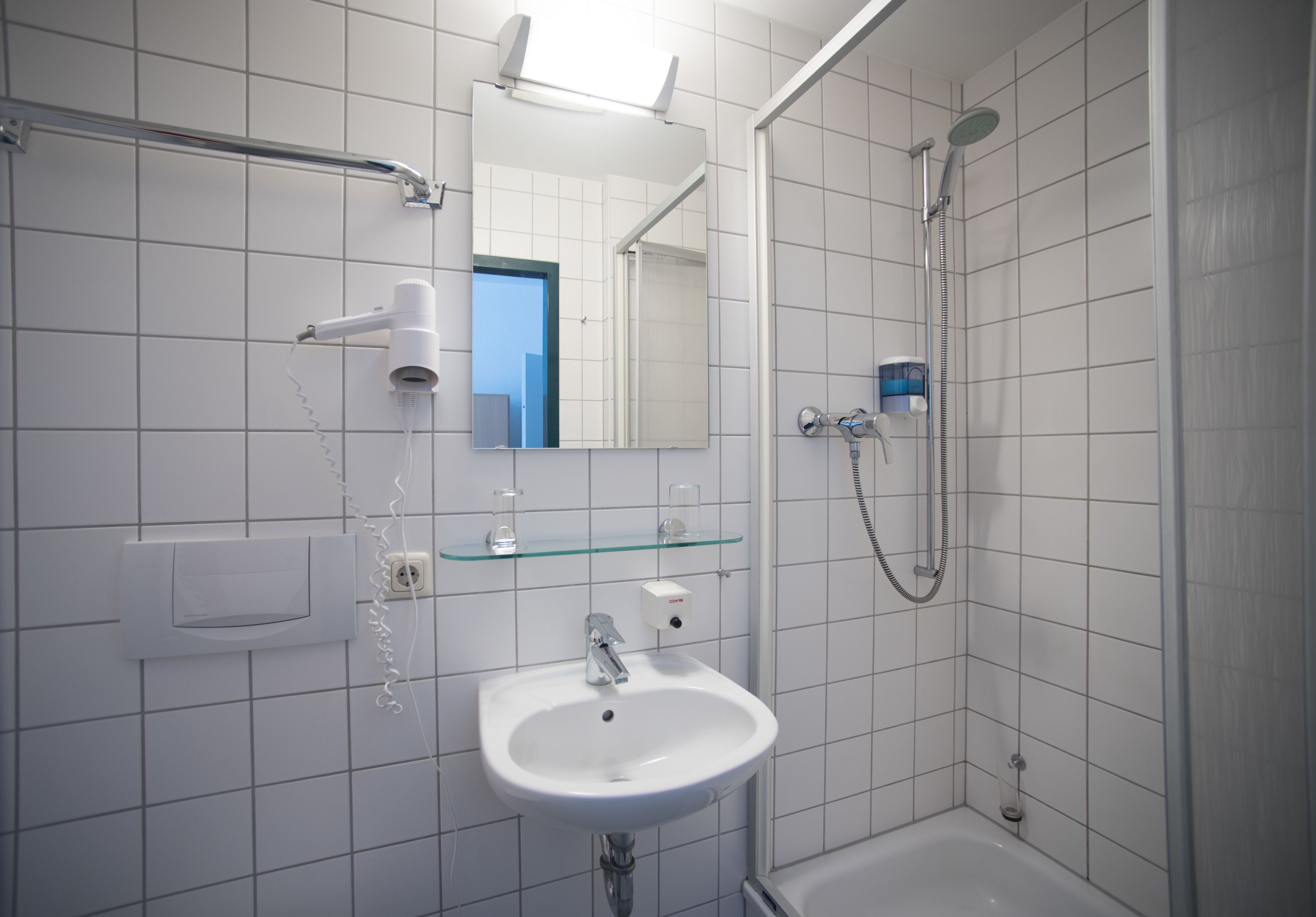 economy twin room | bathroom | shower, free toiletries, hair dryer, towels