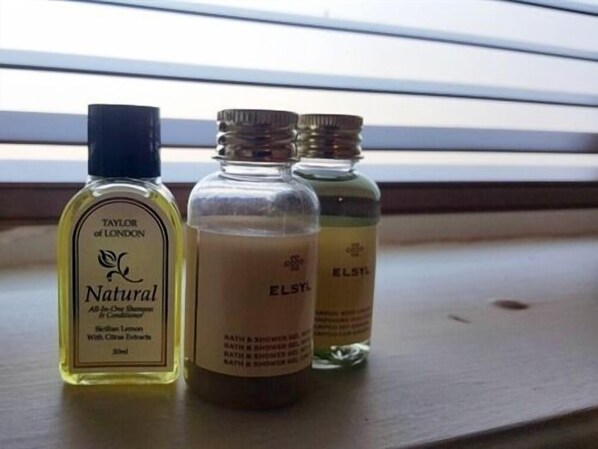 Three bottles of liquid on a windowsill. - Grigshot Apartment (Stroud)