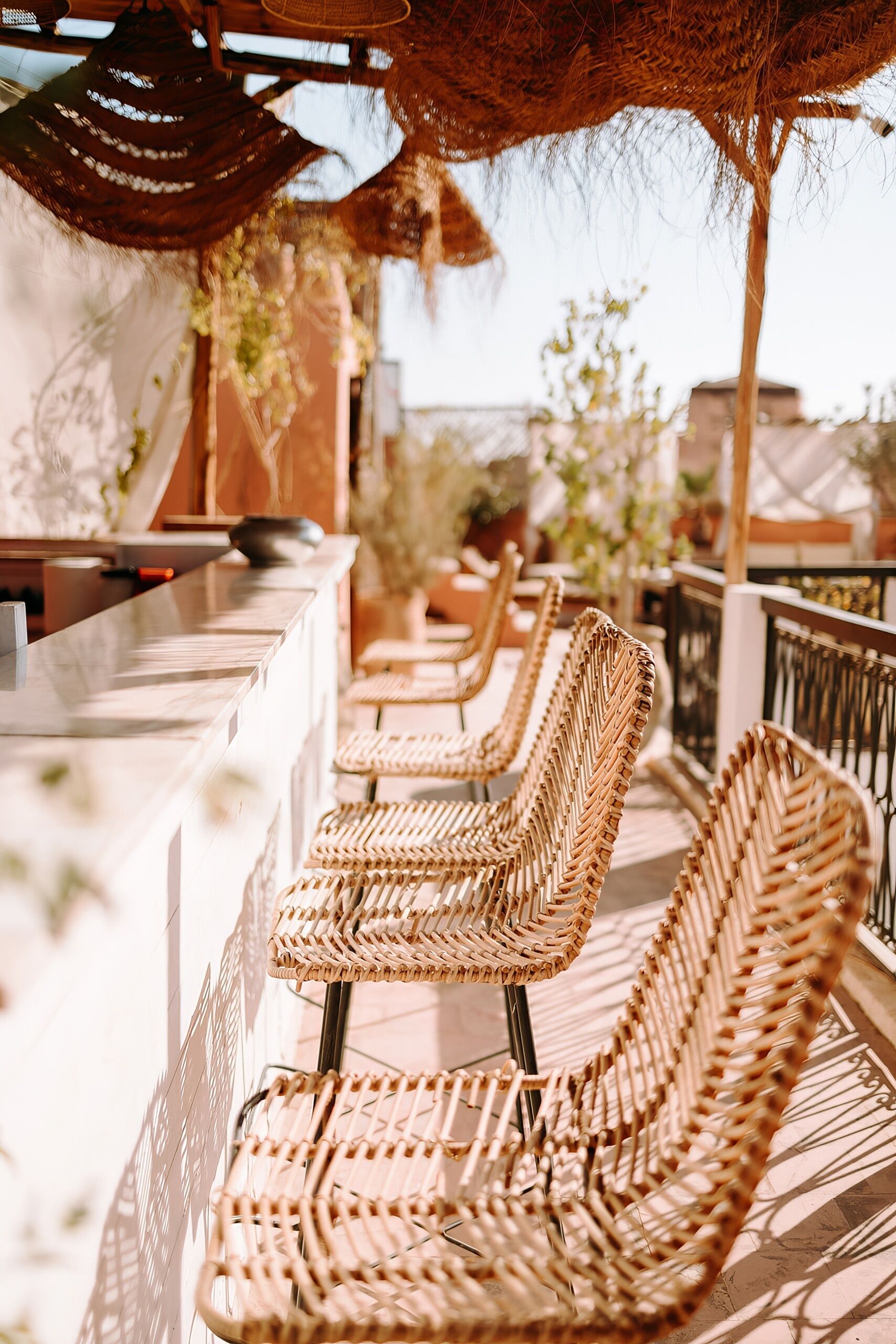 Wicker chairs and a bar area with a thatched roof.