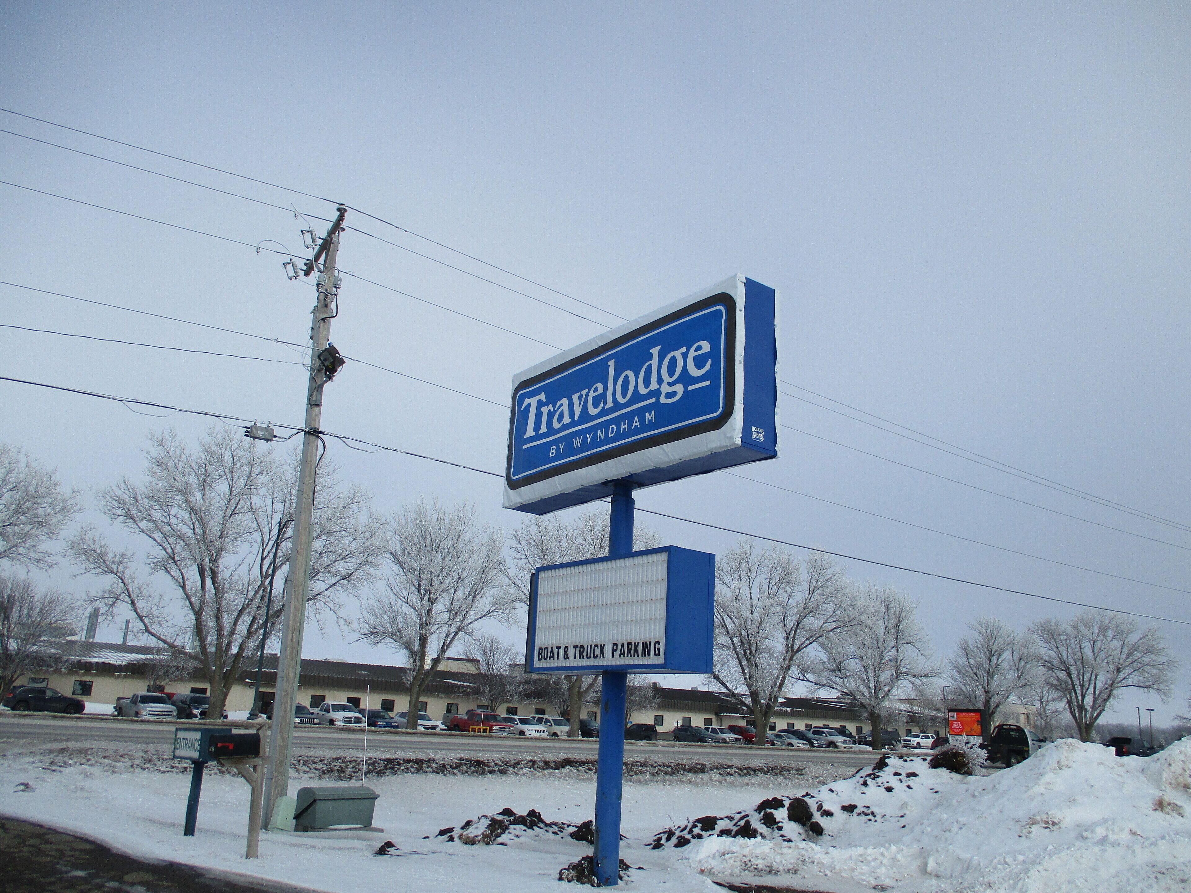 A Travelodge sign with a 'Boat & Truck Parking' sign below it.