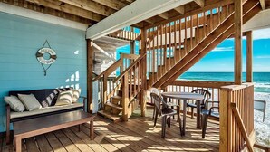 A wooden deck with a bench and chairs, a staircase, and a view of the ocean. - 20 Sanddollar 3 Bedroom Holiday Home by Five Star Properties (Miramar Beach)