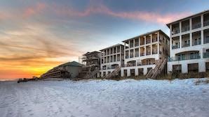 A beachfront hotel with multiple balconies and a staircase leading to the beach. - Bella Vizio 5 Bedroom Holiday Home by Five Star Properties (Miramar Beach)