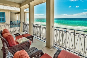 A covered balcony with wicker furniture and a view of the ocean. - Bella Vizio 5 Bedroom Holiday Home by Five Star Properties (Miramar Beach)