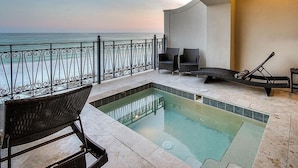A pool area with a view of the ocean, a lounge chair, a sun lounger, and a small table. - Bella Vizio 5 Bedroom Holiday Home by Five Star Properties (Miramar Beach)