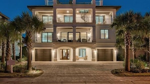 A multi-story residential building with a central courtyard, balconies, and a garage entrance.
