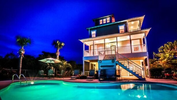 A two-story building with a swimming pool in front.