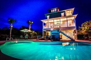A two-story building with a swimming pool in front. - Blue Sky 4 Bedroom Holiday Home by Five Star Properties (Santa Rosa Beach)