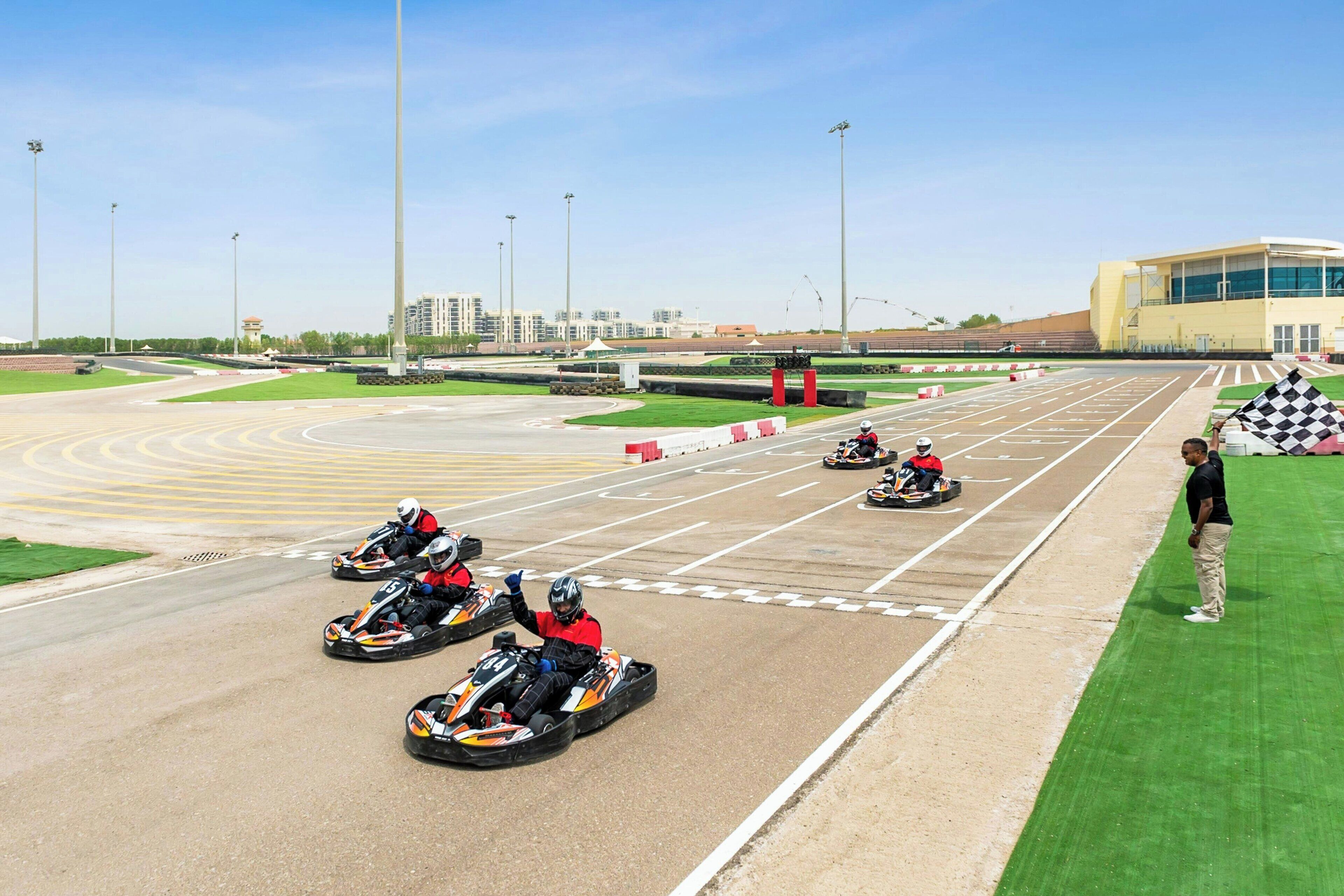 Una pista da go-kart con diverse corsie e una zona verde adiacente.