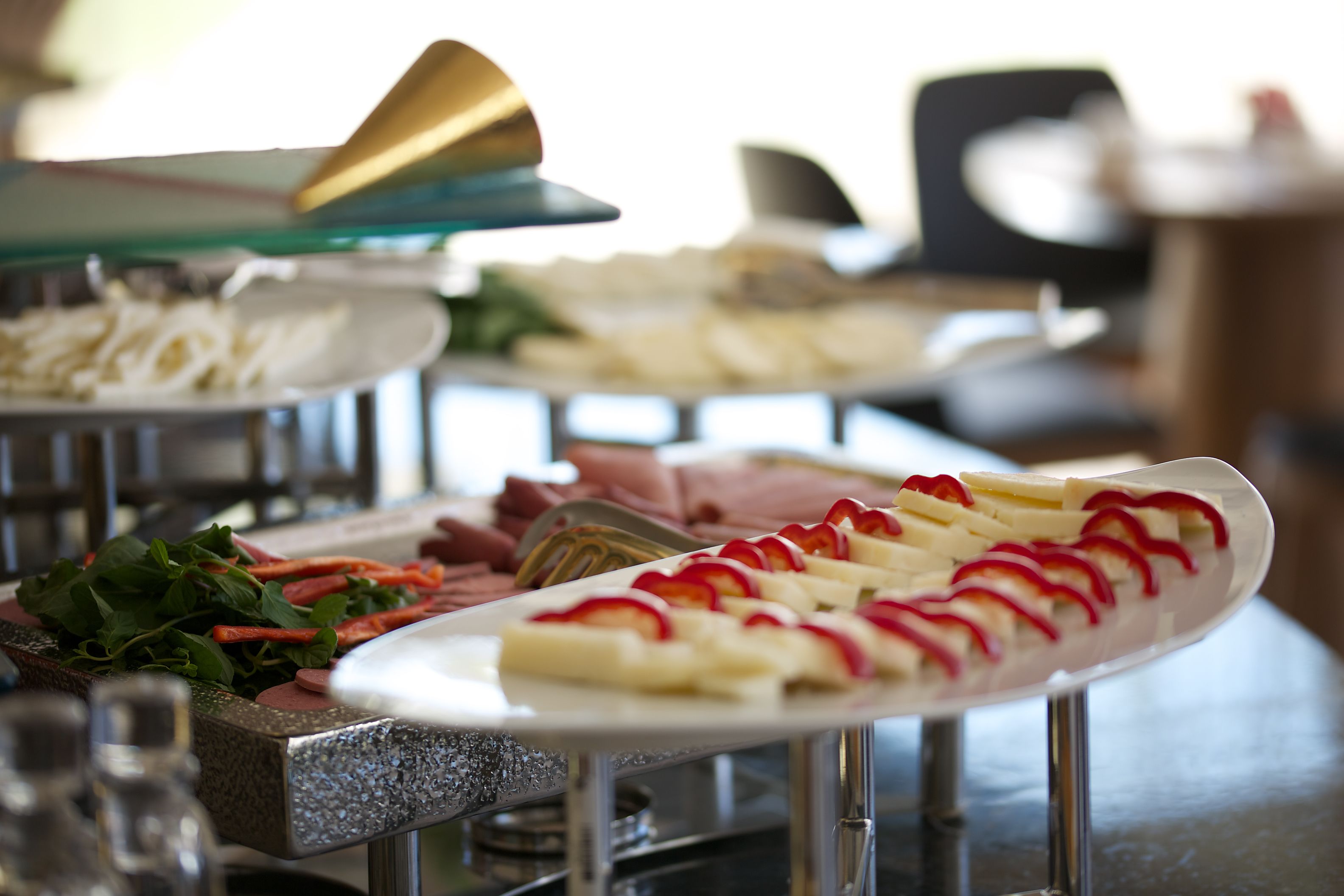 A buffet with various food items including sliced apples and a salad.