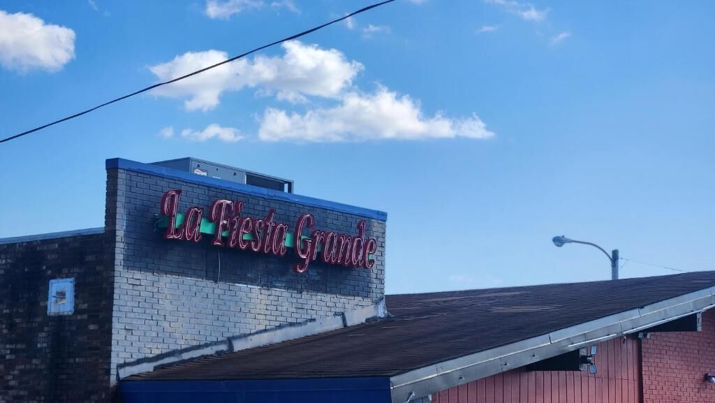 A building with a sign that reads 'La Fiesta Grande.'