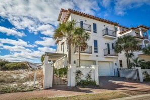 A multi-story residential building with a white facade, red-tiled roof, and balconies. - Vista Bella del Mar 5 Bedroom Holiday Home by Five Star Properties (Santa Rosa Beach)