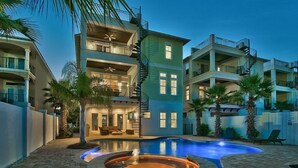 A multi-story residential building with a swimming pool and hot tub.