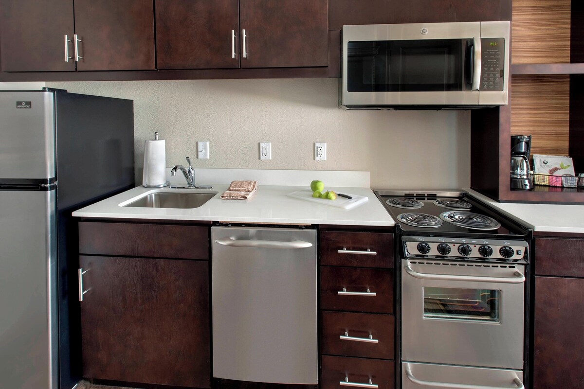 A modern kitchen with stainless steel appliances, a dishwasher, and a double oven.