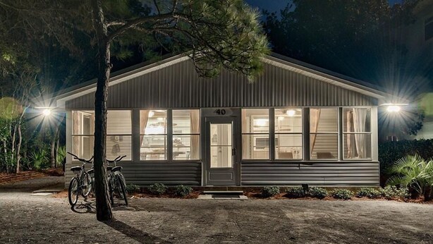 A single-story building with a number "40" on the front door, large windows, and a bicycle parked outside.