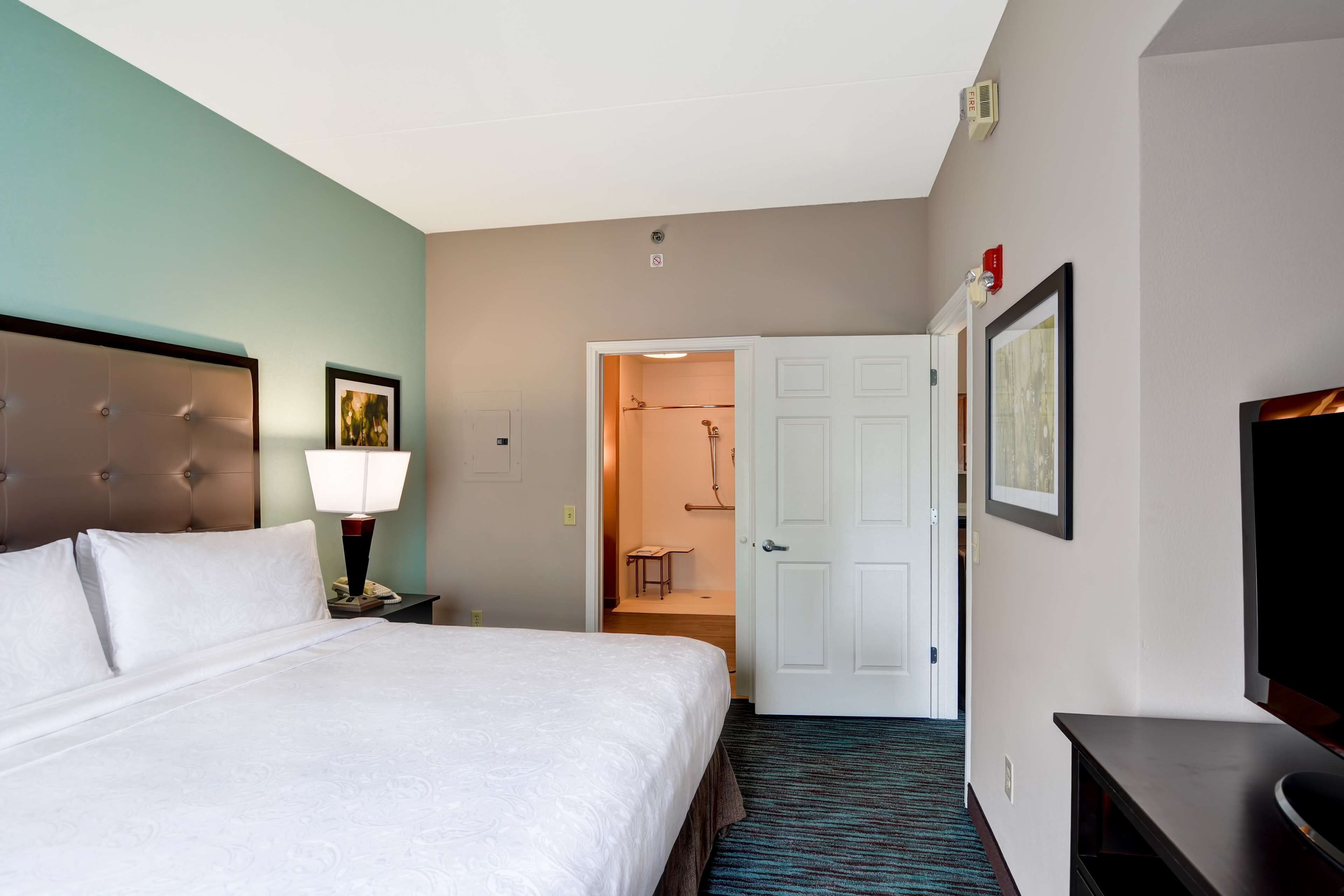 Premium bedding, desk, laptop workspace, blackout curtains
