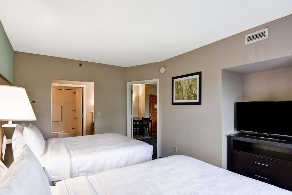 Premium bedding, desk, laptop workspace, blackout curtains