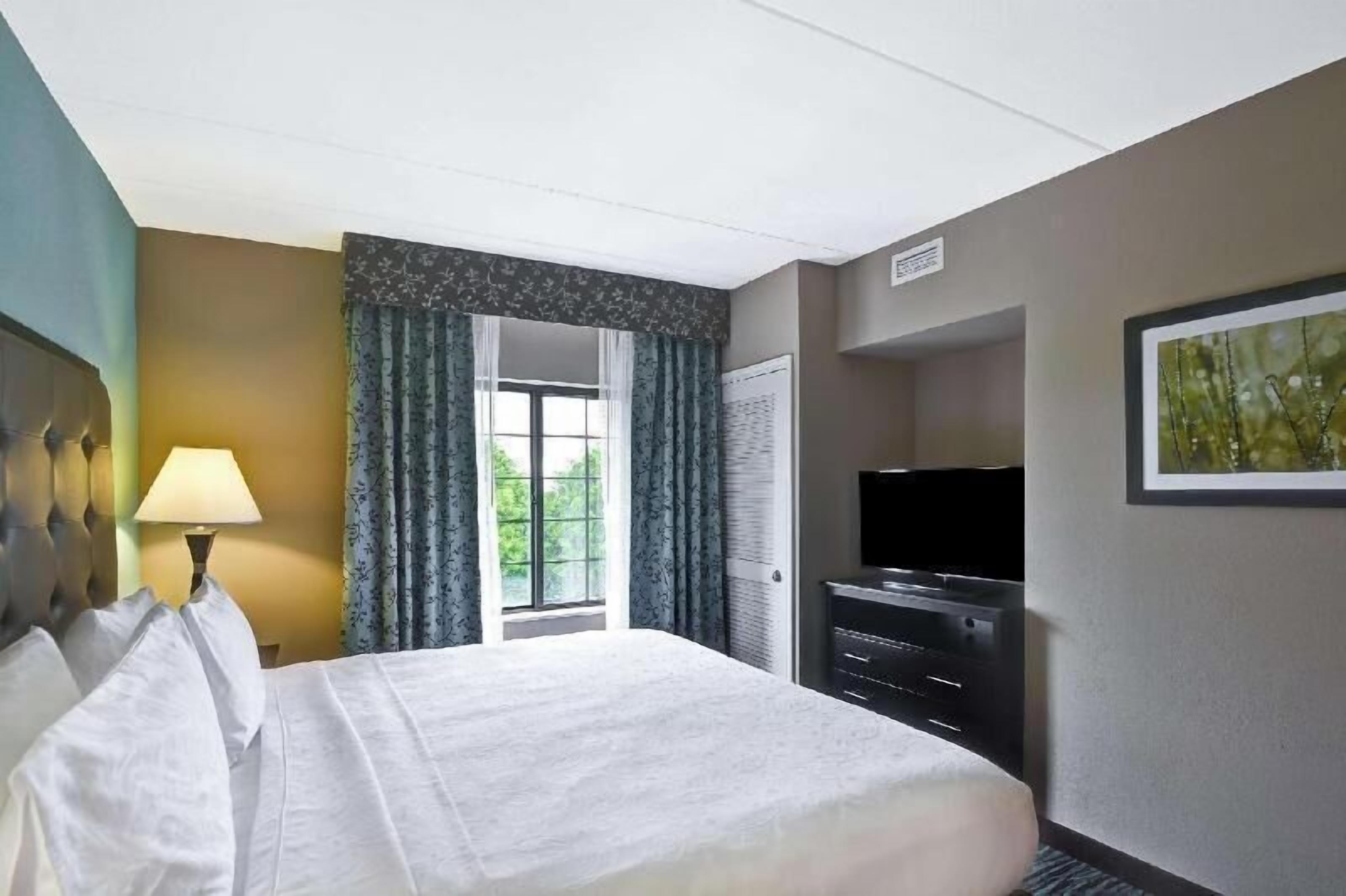 Premium bedding, desk, laptop workspace, blackout curtains