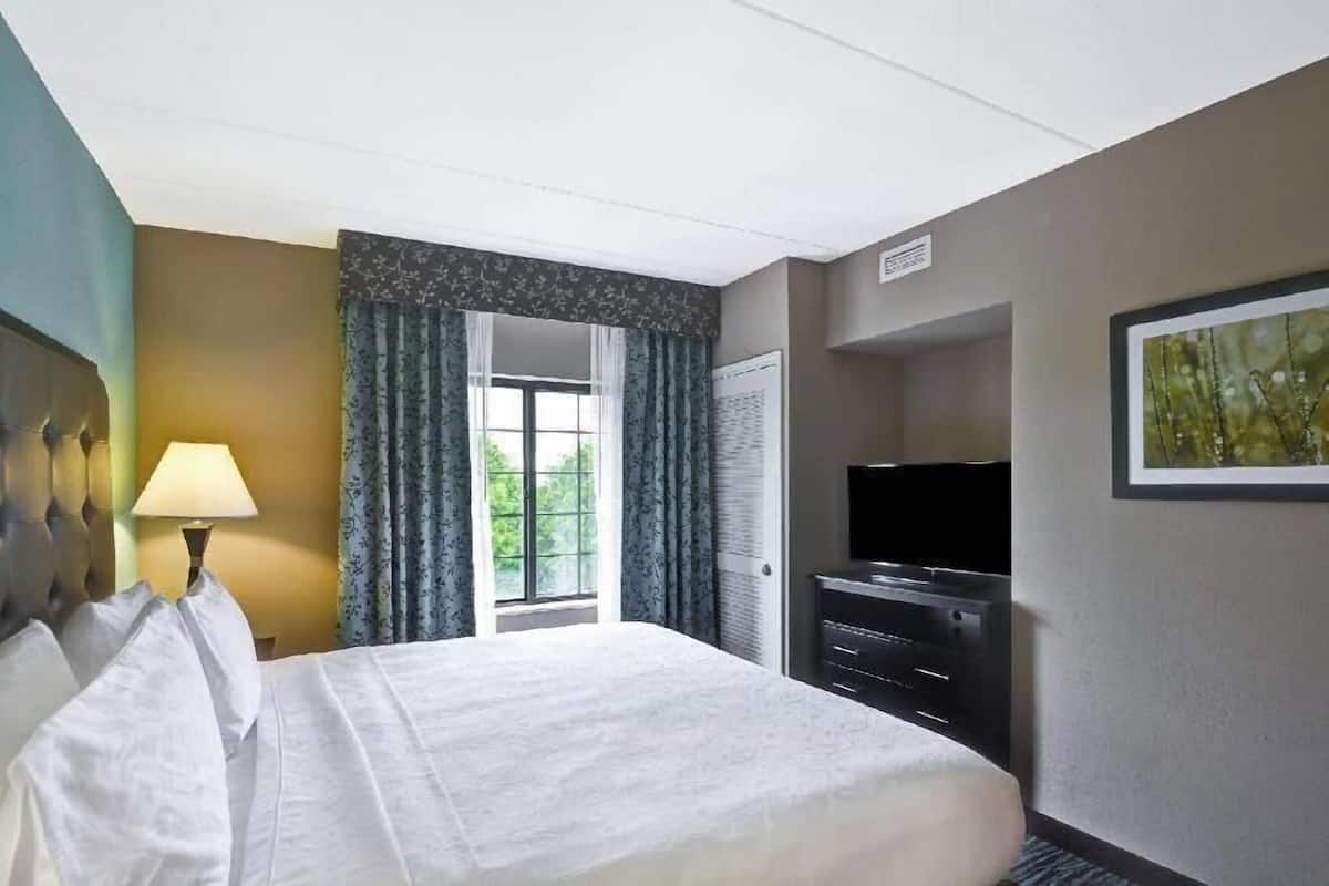 Premium bedding, desk, laptop workspace, blackout curtains