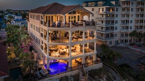 A multi-story hotel with a pool on the ground floor, balconies on each floor, and a view of the surrounding area. - Palazzo del Mar 11 Bedroom Holiday Home by Five Star Properties (Destin)