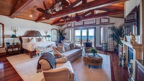 A spacious room with a large bed, a sofa, and a fireplace. - Palazzo del Mar 11 Bedroom Holiday Home by Five Star Properties (Destin)