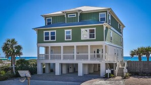 A two-story beachfront house with a balcony, a basketball hoop, and a view of the ocean. - Seaclusion 9 Bedroom Holiday Home by Five Star Properties (Miramar Beach)