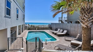 A swimming pool with lounge chairs and a view of the ocean. - Seaclusion 9 Bedroom Holiday Home by Five Star Properties (Miramar Beach)