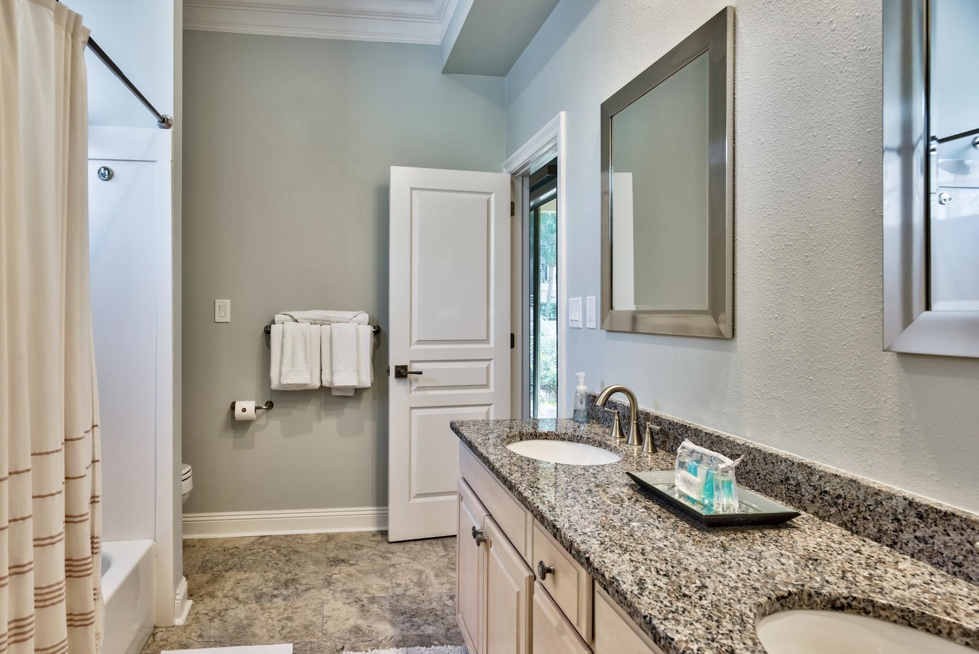 A bathroom with two sinks, a towel rack, and a mirror.