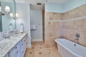 A modern bathroom with a marble vanity, a freestanding bathtub, and a shower area. - SIMMONS TOWNHOUSE 4 Bedroom Holiday Home by Five Star Properties (Panama City Beach)