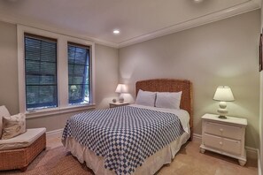 A bedroom with a bed, two bedside tables, a chair, and a window with blinds. - SIMMONS TOWNHOUSE 4 Bedroom Holiday Home by Five Star Properties (Panama City Beach)