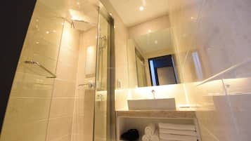 Shower, designer toiletries, hair dryer, bathrobes