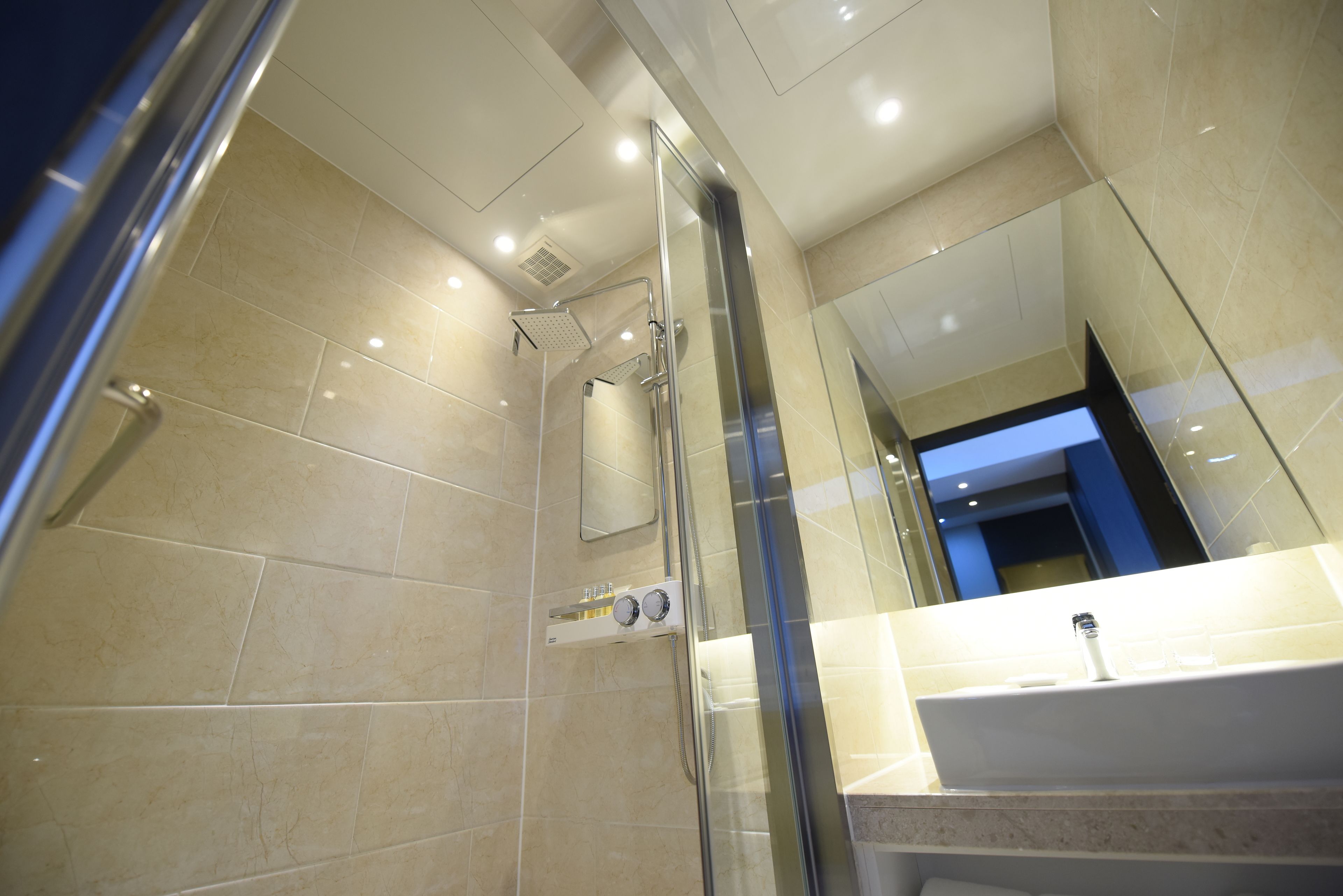 deluxe bath twin room | bathroom | shower, designer toiletries, hair dryer, bathrobes