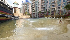 A water park area with a ship-shaped water slide and a child playing in the water. - Grande Caribbean Hotel Resort Pattaya (Pattaya)