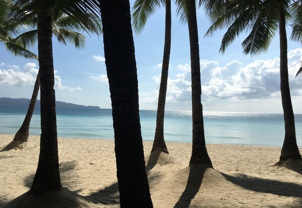 On the beach, white sand, beach towels, motor boating - Luxx Boutique Boracay (Boracay Island)