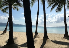 On the beach, white sand, beach towels, motor boating