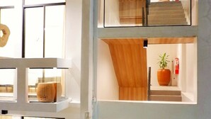 A multi-level interior with glass railings and wooden accents. - Luxx Boutique Boracay (Boracay Island)