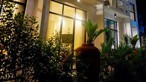 A multi-story hotel with balconies, large windows, and potted plants. - Luxx Boutique Boracay (Boracay Island)