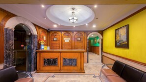 A reception area with marble flooring, a reception desk, and seating. - Treebo Green View, Park Circus (Kolkata)