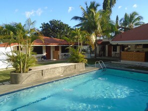 Outdoor pool, open 9:00 AM to midnight, pool umbrellas, sun loungers